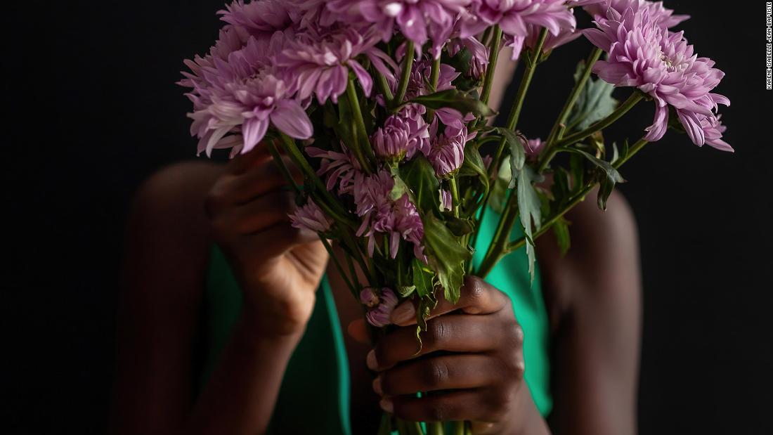&lt;a href=&quot;https://kareneisabelle.format.com/&quot; target=&quot;_blank&quot;&gt;Karene-Isabelle Jean-Baptiste&#39;s&lt;/a&gt; daughter holds flowers that her grandmother brought her to cheer her up on a dreary day during the Covid-19 pandemic. &quot;I found a vintage green dress at a Montreal thrift store years ago,&quot; Jean-Baptiste remembers. &quot;It turns out to have been made in Canada the same year my mother was born to Haiti and many years before she would move here for a different life. Finding the dress felt serendipitous, and when my daughter dresses up in it I feel the continuity between the previous owner of the dress and my family who emigrated to Canada for a better life. My hope is that we, too, get to pass on this dress from generation to generation.&quot;