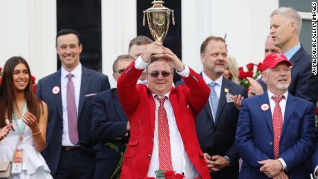 Trainer Eric Reed holds the trophy after Rich Strike&#39;s victory at the 148th running of the Kentucky Derby. 