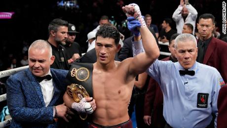 Bivol celebrates after beating Alvarez in their match for the light heavyweight title.