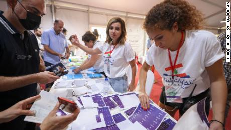 Lebanese expats check lists with electoral staff before casting their votes for the May 15 legislative election at Lebanon&#39;s consulate in Dubai on May 8.