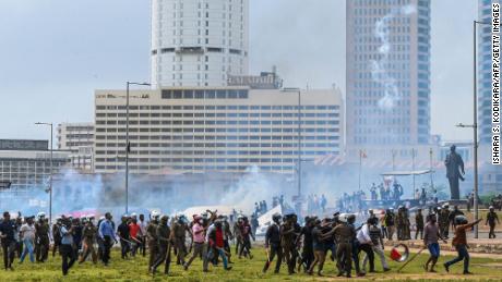 Pro and anti-government groups clash on Monday.