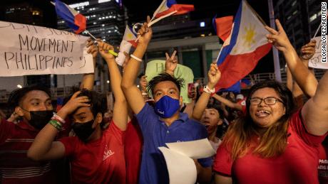 Supporters of presidential candidate Ferdinand &quot;Bongbong&quot; Marcos Jr. celebrate as partial results of the 2022 national elections show him with a wide lead over rivals, outside the candidate&#39;s headquarters in Mandaluyong City, Philippines, on May 9.