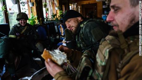 Yaroslav Amosov, resting his head on his hands, with the rest of his fellow Ukrainian soldiers as they prepare to face Russian forces in Irpin, Ukraine.