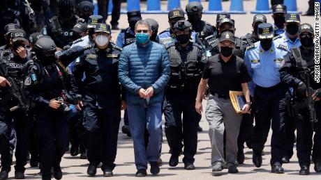 Hernández is escorted by members of the special police forces in Tegucigalpa ahead of his extradition.