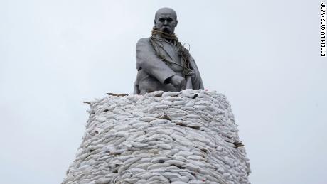 A statue of Ukrainian poet, Taras Shevchenko, is covered with bags to protect it from shelling in Kharkiv, pictured in March.