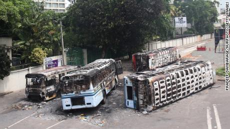 Burned buses near the official residence of Sri Lanka&#39;s outgoing Prime Minister, Mahinda Rajapaksa, in Colombo, a day after they were torched by protesters on May 10. 