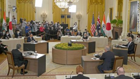 Japanese Prime Minister Yoshihide Suga (back, L) attends a Quad summit meeting with the leaders of the United States, Australia and India at the White House in Washington on Sept. 24, 2021. (Photo by Kyodo News via Getty Images)