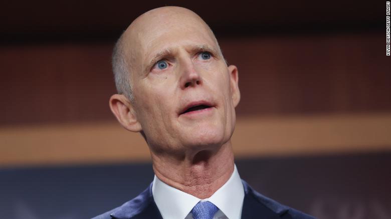 Rick Scott signed a law raising the age to buy a gun in Florida. Now he opposes doing that at the federal level