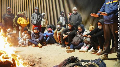 Cubans who have just crossed the US-Mexico border huddled near a fire in Yuma, Arizona in February.