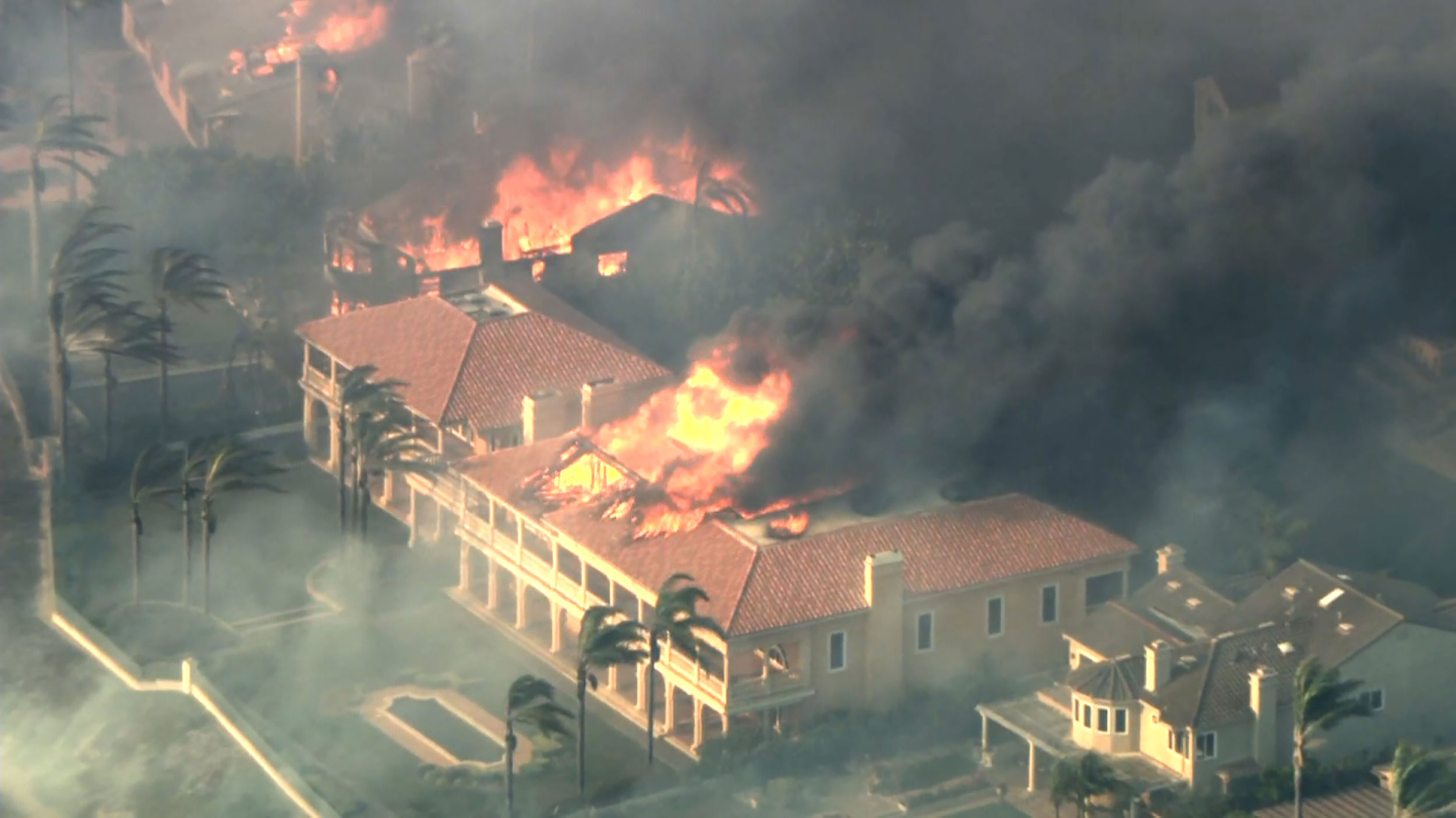 At least 20 homes in Southern California engulfed by a fast-moving blaze as authorities urge evacuations