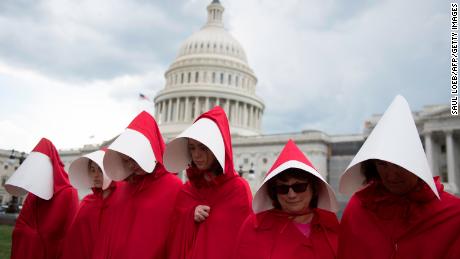 Supporters of Planned Parenthood dressed as characters from &quot;The Handmaid's Tale,&quot; at a rally outside the US Capitol in Washington, DC, June 27, 2017.