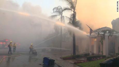 Firefighters attempt to contain a fire in Orange County, California, Wednesday.