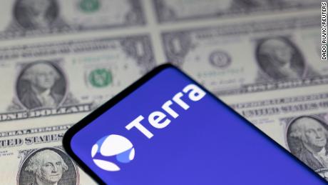 Smartphone with Terra logo is placed on displayed U.S. dollars in this illustration taken May 11, 2022. Illustration taken May 11, 2022. REUTERS/Dado Ruvic/Illustration