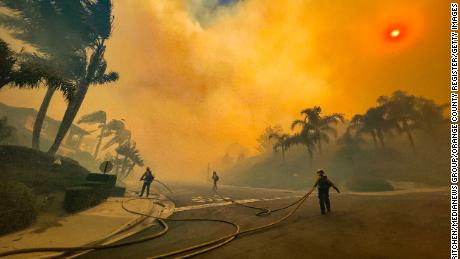 Firefighters battle the Coastal Fire on Wednesday in Laguna Niguel.
