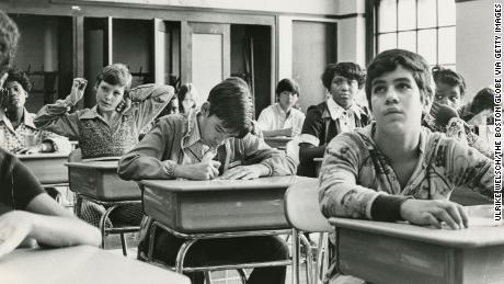 Eighth grade students on September 12, 1974 in Boston, Mary E.  Curley sits in an integrated classroom at the school, the first day of school under the new busing system to separate the schools.