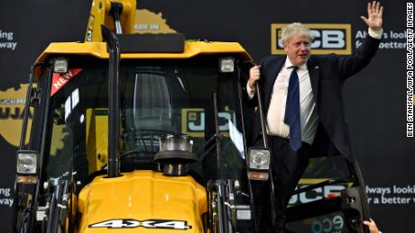 British Prime Minister Boris Johnson waves from a digger at a JCB factory in Gujarat, during his trip to India in April.