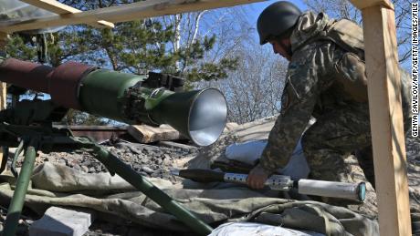 A Ukrainian soldier prepares a rocket launcher on the front line, near Kyiv on March 20, 2022.