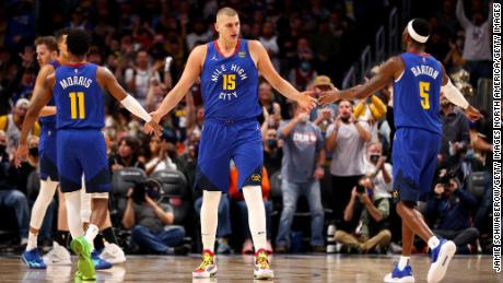 Jokic celebrates with his teammates after a basket against the San Antonio Spurs on October 22, 2021.