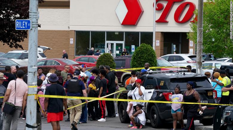 People gather outside a supermarket in Buffalo, New York, where 10 people were killed on Saturday.