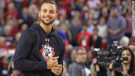 Steph Curry smiles on the court during a ceremony to name the student section at Davidson College&#39;s John M. Belk Area after him, on January 24, 2017.