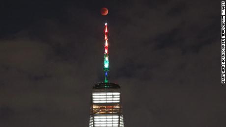 The blood moon rises over lower Manhattan and One World Trade Center in New York City on May 15, 2022. 