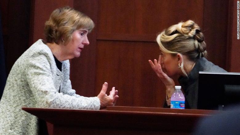 Amber Heard talks to her lawyer Elaine Bredehoft in the courtroom at the Fairfax County Circuit Courthouse on Monday.