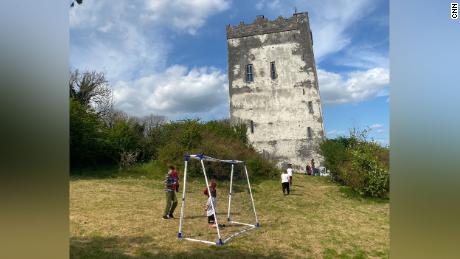 Children staying at Ballindoley Castle in Galway play freely in the park.