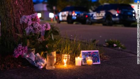 A small vigil is set up across the street from a Topps grocery store in Buffalo, New York, where a heavily armed 18-year-old white man shot 13 people on May 14, killing 10 .