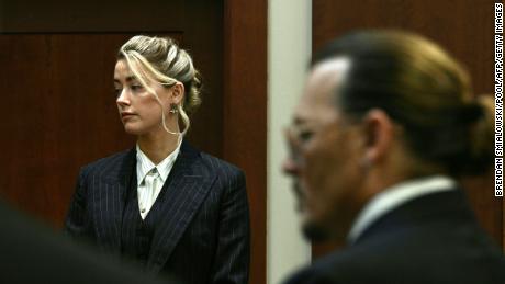 Amber Heard and Johnny Depp watch as the jury comes into the courtroom on Tuesday.
