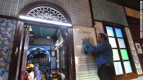 A man is cleaning a plaque at Ghriba Synagogue on the Tunisian holiday island of Djerba on Tuesday, on the eve of the annual Jewish pilgrimage to the synagogue.  The Jewish community in Tunisia, dating back to Roman times and once numbering 100,000 people, has shrunk to just 2,000 after fear, poverty and discrimination sparked waves of emigration following Israel's founding in 1948. There are more than 1,200 Jews in Djerba. 
