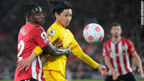 Southampton&#39;s Mohammed Salisu, left, challenges for the ball with Liverpool&#39;s Takumi Minamino.