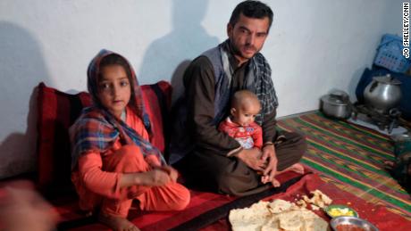 Waliullah and her family sit down to dinner in their home on the outskirts of Kabul.