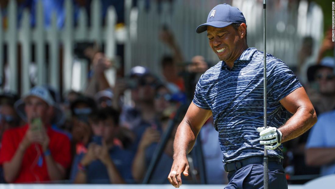 Tiger Woods reacts after his shot from the eighth tee during the first round.