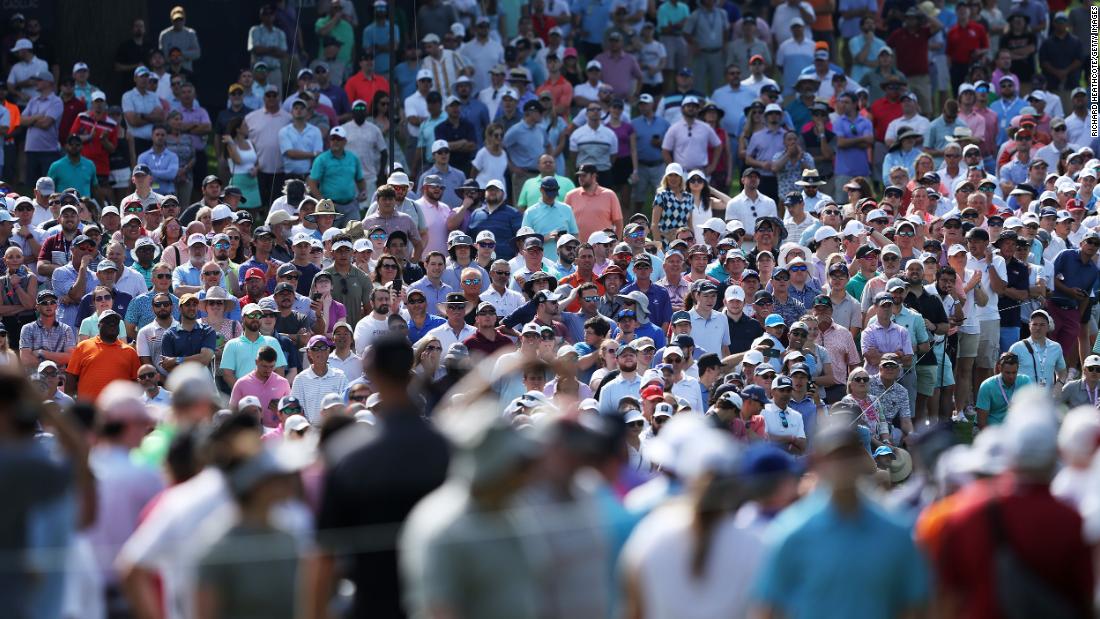 Fans watch on the 14th hole during the first round.