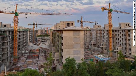 China cuts key interest rate as housing sales plummet
