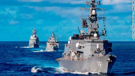 Ships from Japan Maritime Self-Defense Force and Indian Navy sail in formation with Royal Australian Navy HMAS Warramunga and Arleigh Burke-class guided-missile destroyer USS Barry during the Malabar exercise in August 2021.