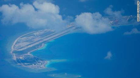 A Chinese air strip lies beside structures and buildings at the man-made island on Mischief Reef at the Spratly group of islands in the South China Sea are seen on Sunday March 20, 2022. 