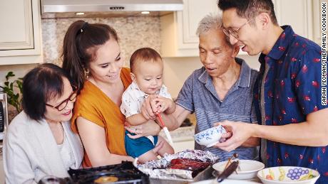 Three generations of the Lau family gather in their kitchen. Left to right: Jenny, Kat, Cameron, Chung Sun (&quot;Daddy Lau&quot;) and Randy.