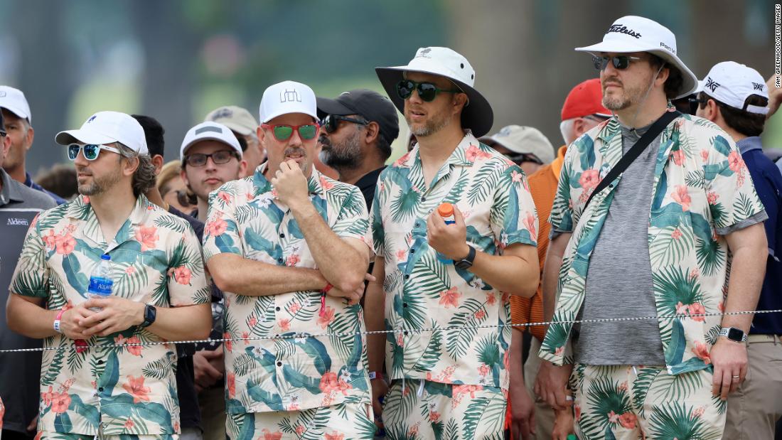 Fans dressed in matching Hawaiian shirts and shorts watch the action during the second round.