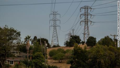 Power lines stand in Crockett, California, U.S., on Monday, Aug. 17, 2020. As many as 10 million Californians were supposed go dark on Monday in an unprecedented series of rolling blackouts designed to save the power grid from the worst heat wave in 70 years. But temperatures fell, people turned down their air conditioners and utilities called off the outages. Photographer: David Paul Morris/Bloomberg via Getty Images