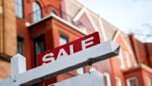 A For Sale sign is displayed in front of a house in Washington, DC, on March 14, 2022. 