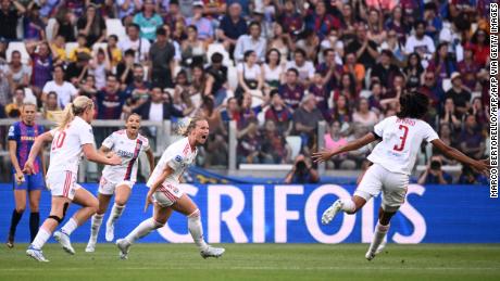 Amandine Henry celebrates with her teammates after scoring Lyon&#39;s opening goal against Barcelona.