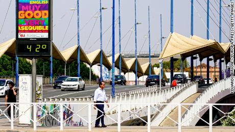 A city thermometer on the Puente del Cachorro bridge reads 42 degrees in Seville.