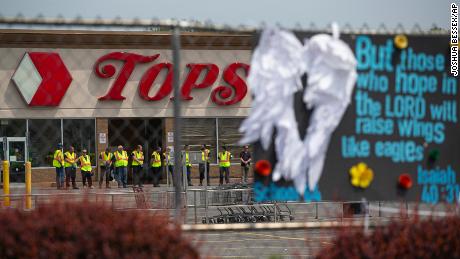 Investigators stand outside the Tops Friendly Market on Saturday, May 21, 2022, in Buffalo, New York.