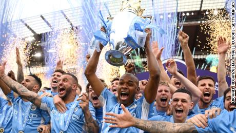 Manchester City lifts the trophy after a memorable title race against Liverpool.