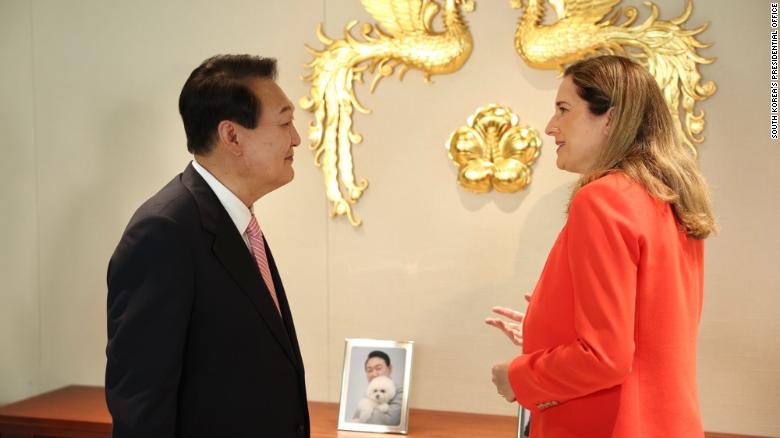 Yoon speaks with CNN&#39;s international correspondent Paula Hancocks on May 23 in the presidential office, decorated with a framed photo of Yoon with one of his family&#39;s many pets, which include four dogs and three cats.