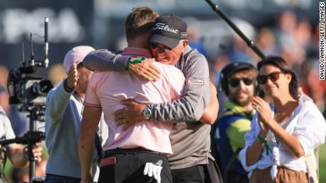 Thomas is congratulated after his victory by his father Mike Thomas, on the 18th green.