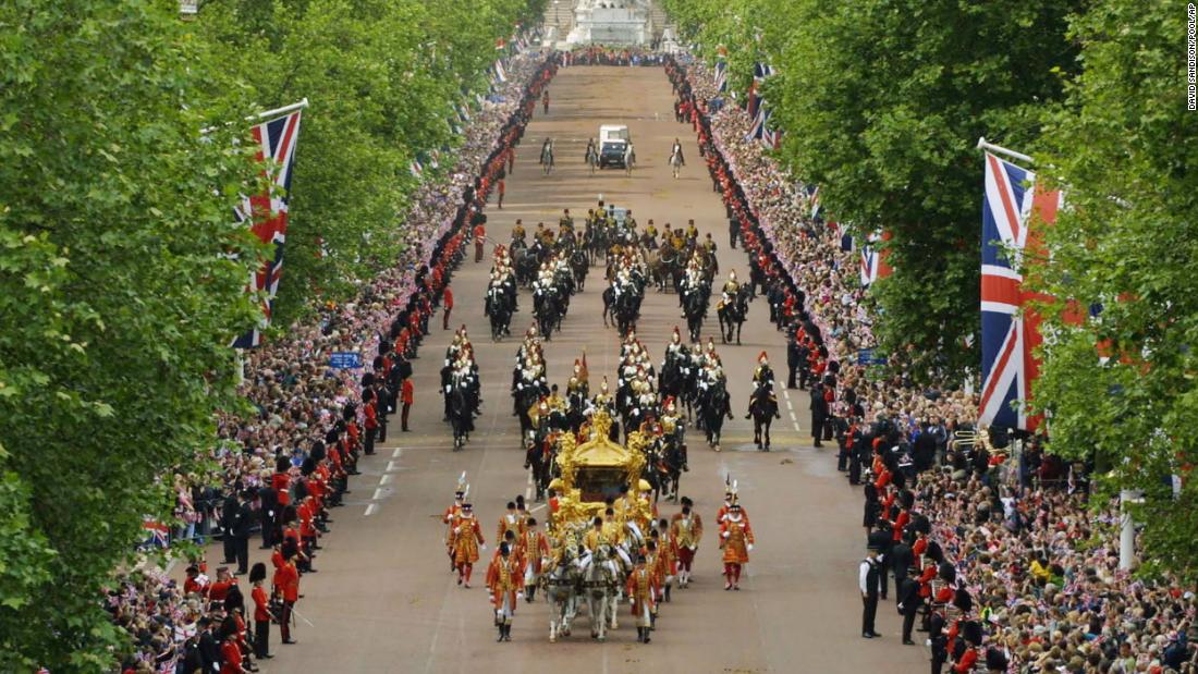 Huge crowds flood both sides of the Mall in central London to see the Queen and the Duke of Edinburgh travel to St. Paul&#39;s Cathedral for a service of thanksgiving to celebrate the Golden Jubilee, on June 4, 2002.