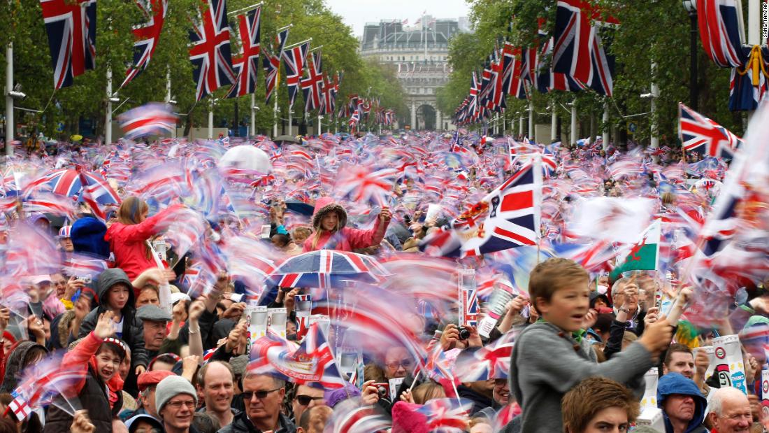 The Mall is awash with red, white and blue as revelers pack in to watch the royal family take to the Buckingham Palace balcony.