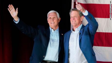 Former Vice President Mike Pence, left, and Georgia Gov. Brian Kemp, right, greet the crowd during a Get Out the Vote Rally, on Monday, May 23, 2022, in Kennesaw, Ga. Pence is opposing former President Donald Trump and his preferred Republican candidate for Georgia governor, former U.S. Sen. David Perdue.